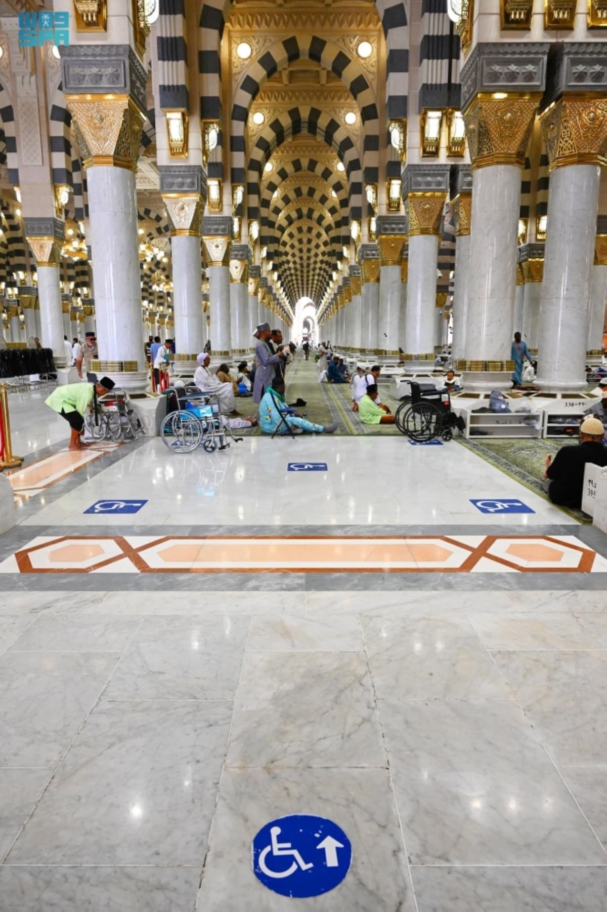 Elderly and disabled pilgrims receiving assistance at the Prophet's Mosque during Hajj.