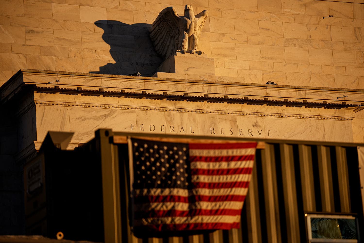 Federal Reserve building with financial graphs overlay