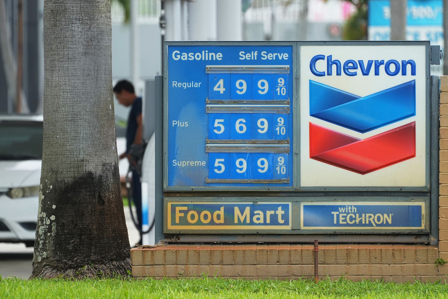 A gas station sign displaying rising fuel prices amidst geopolitical unrest.