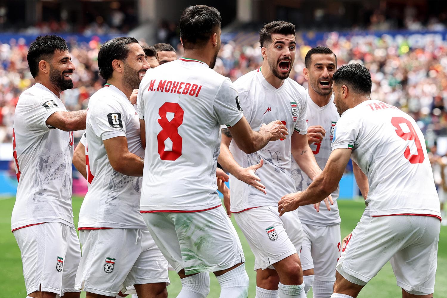Iran's national soccer team celebrating their draw against Belgium in the World Cup.
