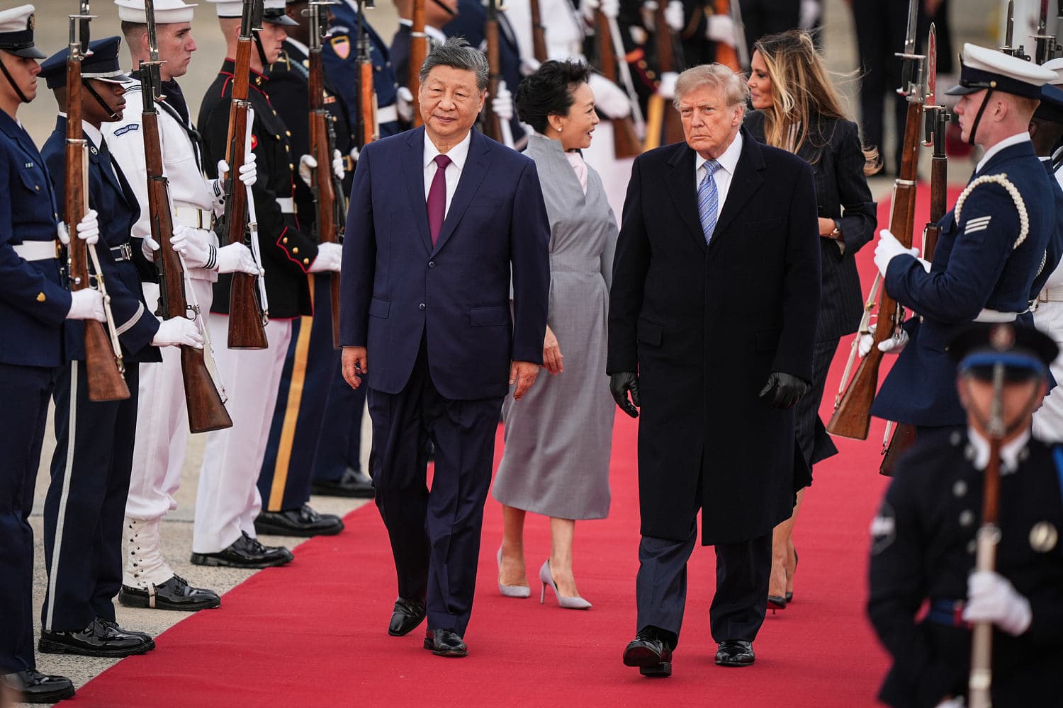 Trump and Xi Jinping shaking hands at the White House with military honors in the background.