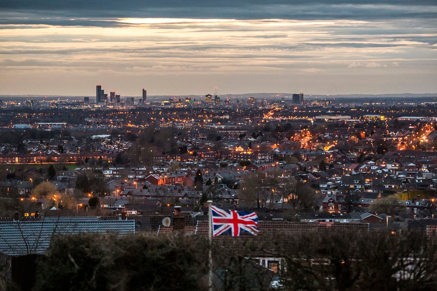 Graphic showing the number "2" against Manchester's skyline, representing the charged Iranian nationals in a terrorism plot.