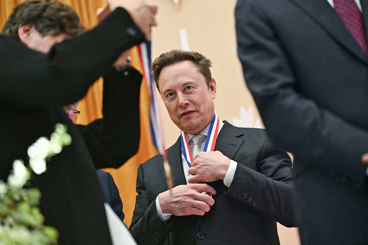 Infographic showing Musk and Anthropic's pledges to address AI's economic impact on jobs.