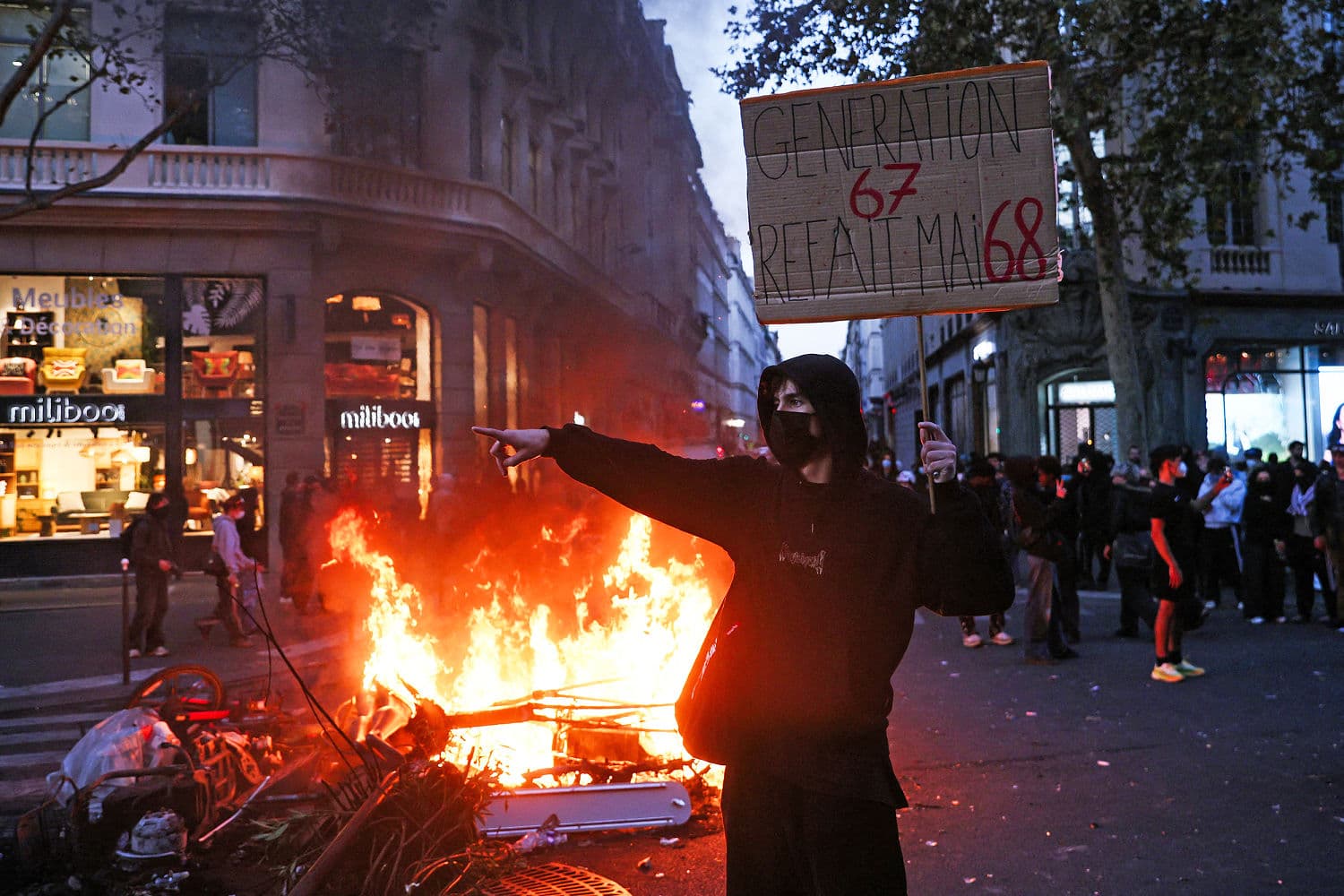 Protesters clashing with police in France, highlighting civil unrest and economic discontent.