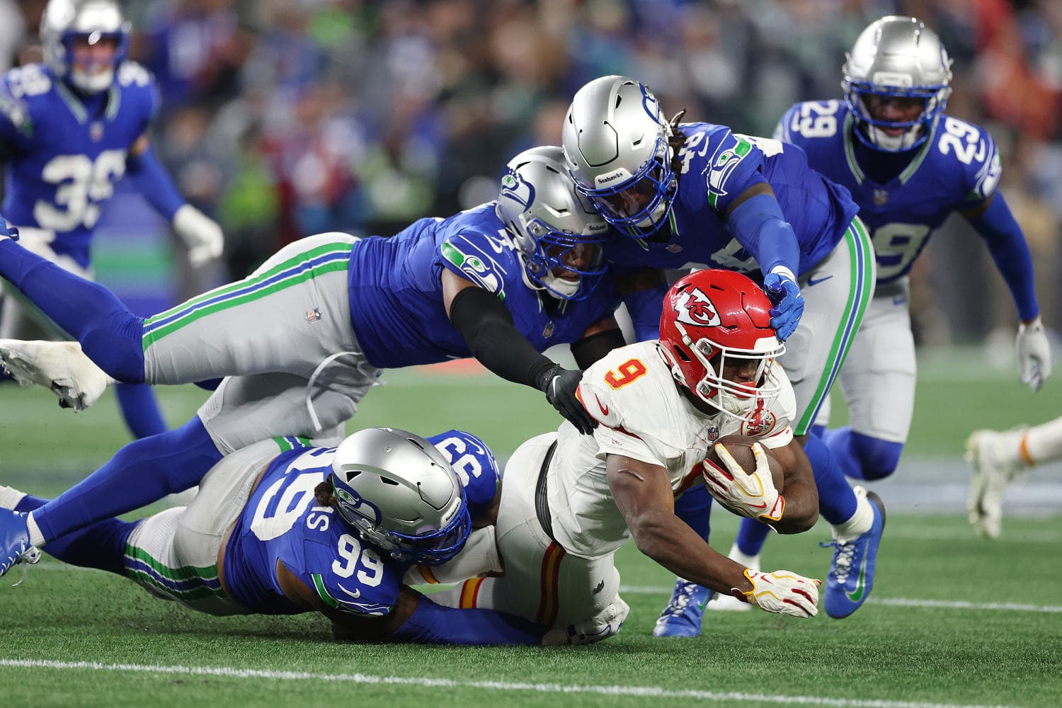 Seattle Seahawks defense swarms Kansas City Chiefs offense during regular season game at Lumen Field