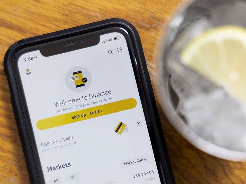 Binance logo with a backdrop of EU regulatory symbols