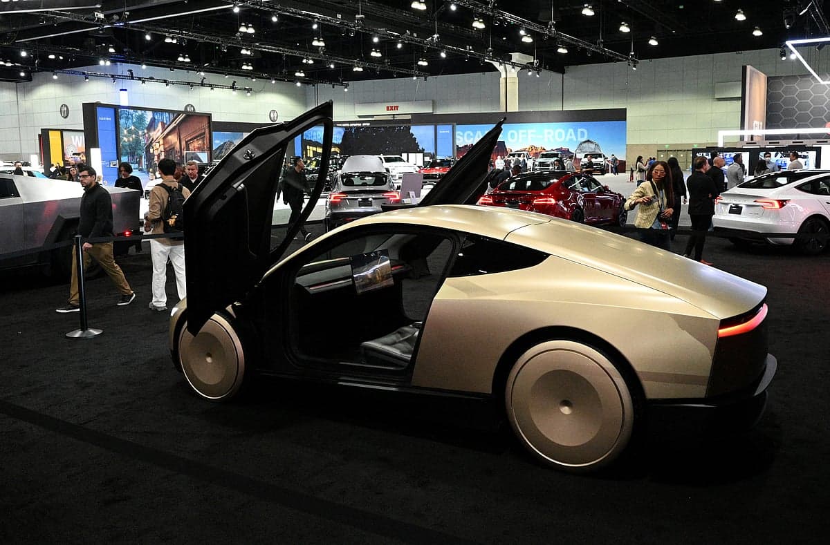 A futuristic Tesla Cybercab robotaxi parked in an urban setting, highlighting its design and technology.