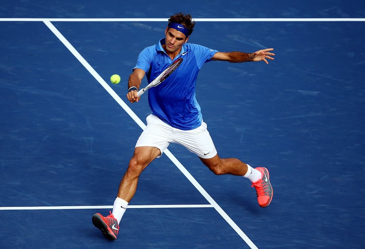 Roger Federer playing in an exhibition match at the US Open, showcasing his legacy in tennis.