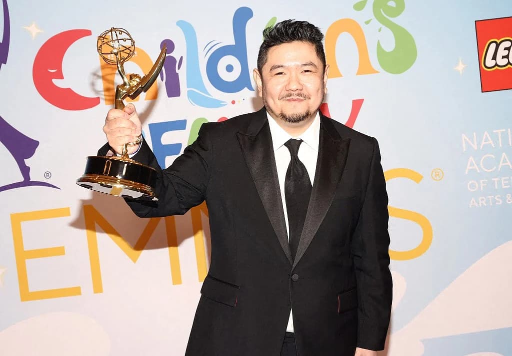 Bold graphic display highlighting 935 voice roles honoring deceased voice actor Eric Bauza.