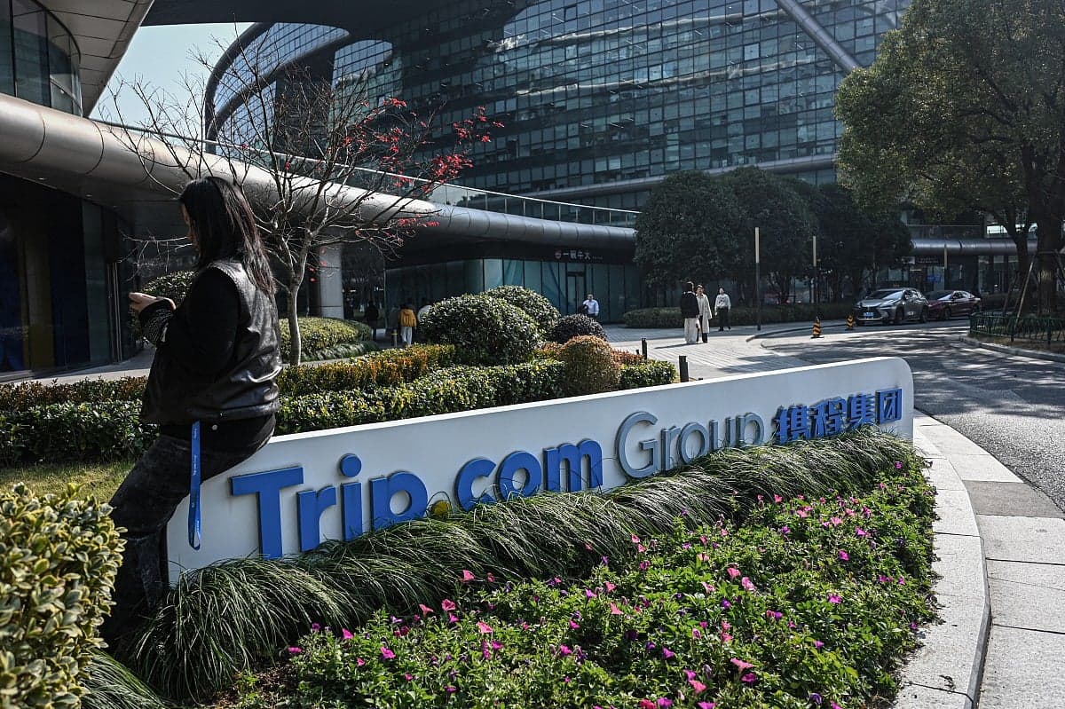Trip.com logo with a backdrop of regulatory documents and fines