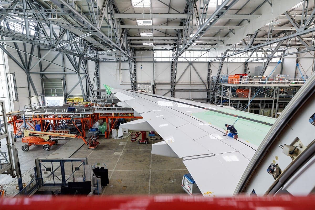 Airbus A380 aircraft undergoing inspection for wing component safety.