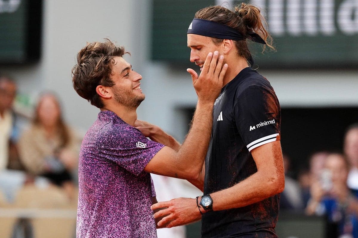Alexander Zverev celebrating his first Grand Slam title at the 2026 French Open, holding the trophy aloft.