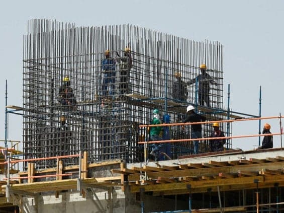 Saudi workers in protective gear during extreme heat conditions