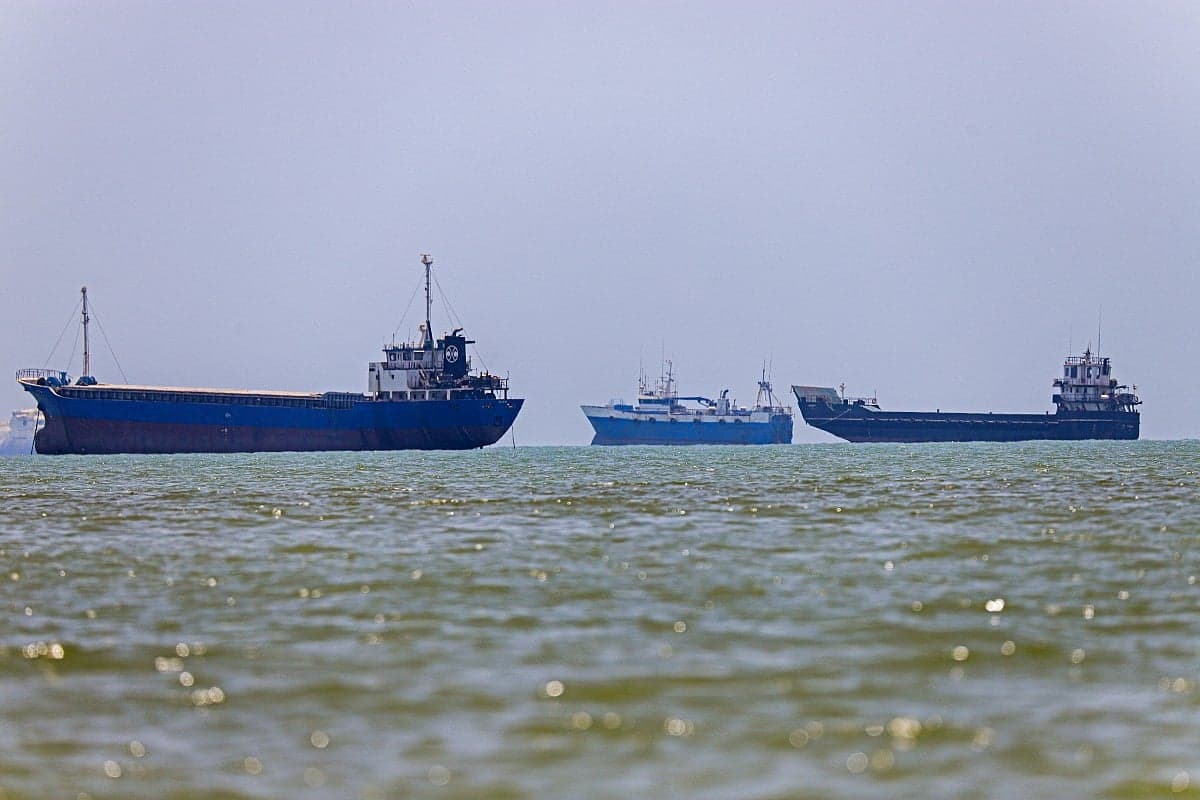 Ships navigating the Strait of Hormuz with a focus on maritime policy changes.