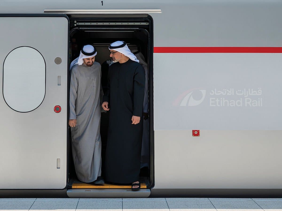 Etihad Rail train on tracks with UAE skyline in the background