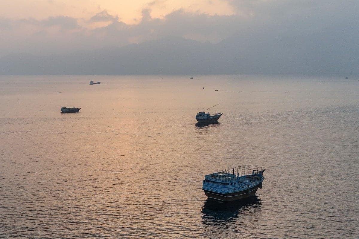 A tanker ablaze in the Strait of Hormuz, highlighting maritime security risks.