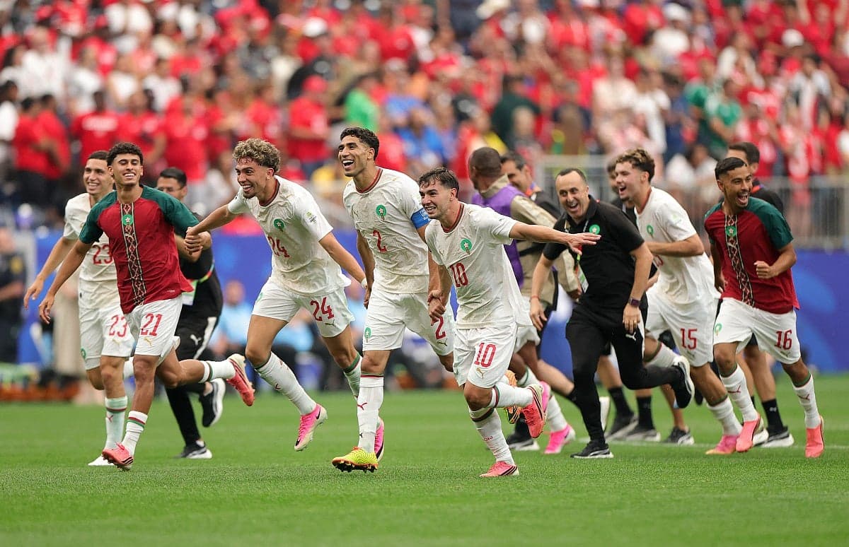 Moroccan football team celebrating their victory over Canada in the World Cup.