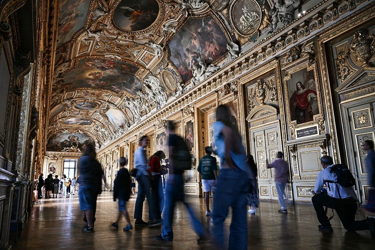 The Apollo Gallery at the Louvre Museum showcasing its historical decor after reopening.