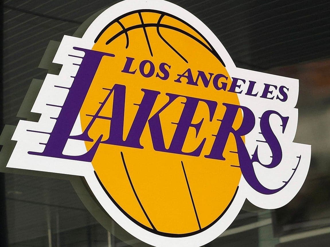 Los Angeles Lakers logo with a backdrop of financial charts