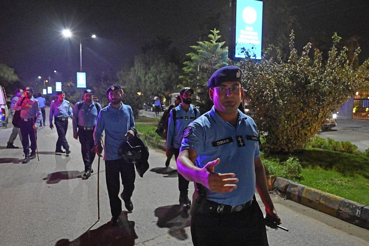 Imran Khan being escorted back to Adiala Jail after a medical examination, reflecting his ongoing legal battles.
