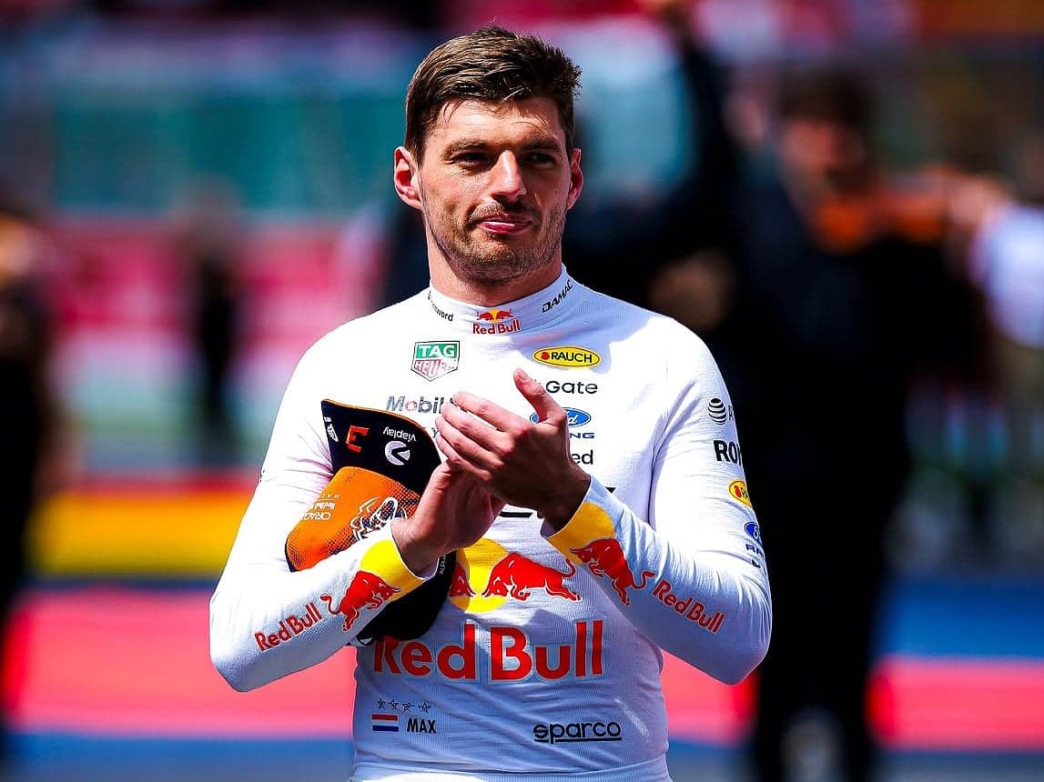 Max Verstappen celebrating his contract extension with Red Bull Racing, highlighting his achievements in Formula One.