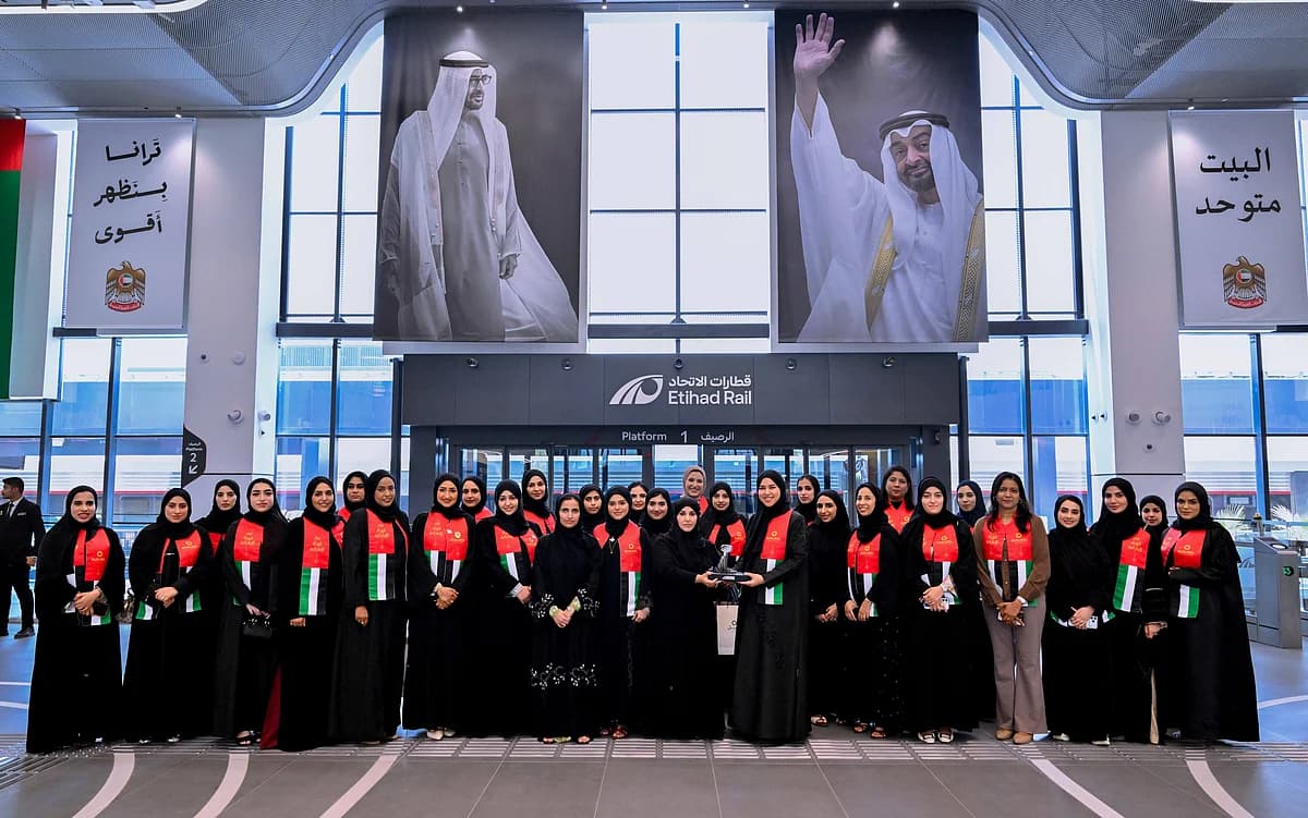 Emirati women in healthcare discussing leadership during a train journey, symbolizing empowerment and collaboration.
