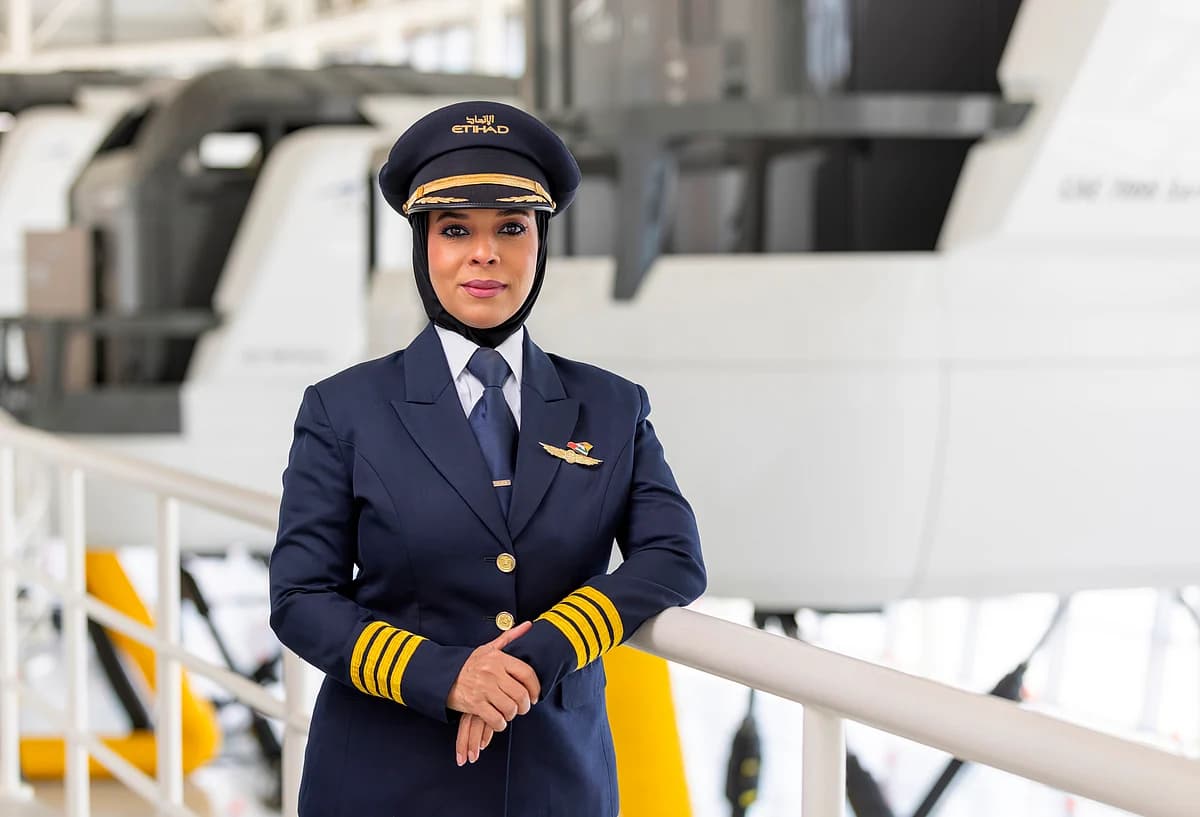 Captain Huda Al Musallami in pilot uniform, representing gender equality in aviation leadership.