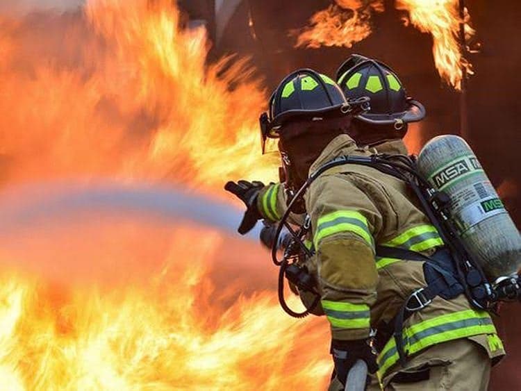 A somber image depicting the aftermath of a factory fire in Riyadh.