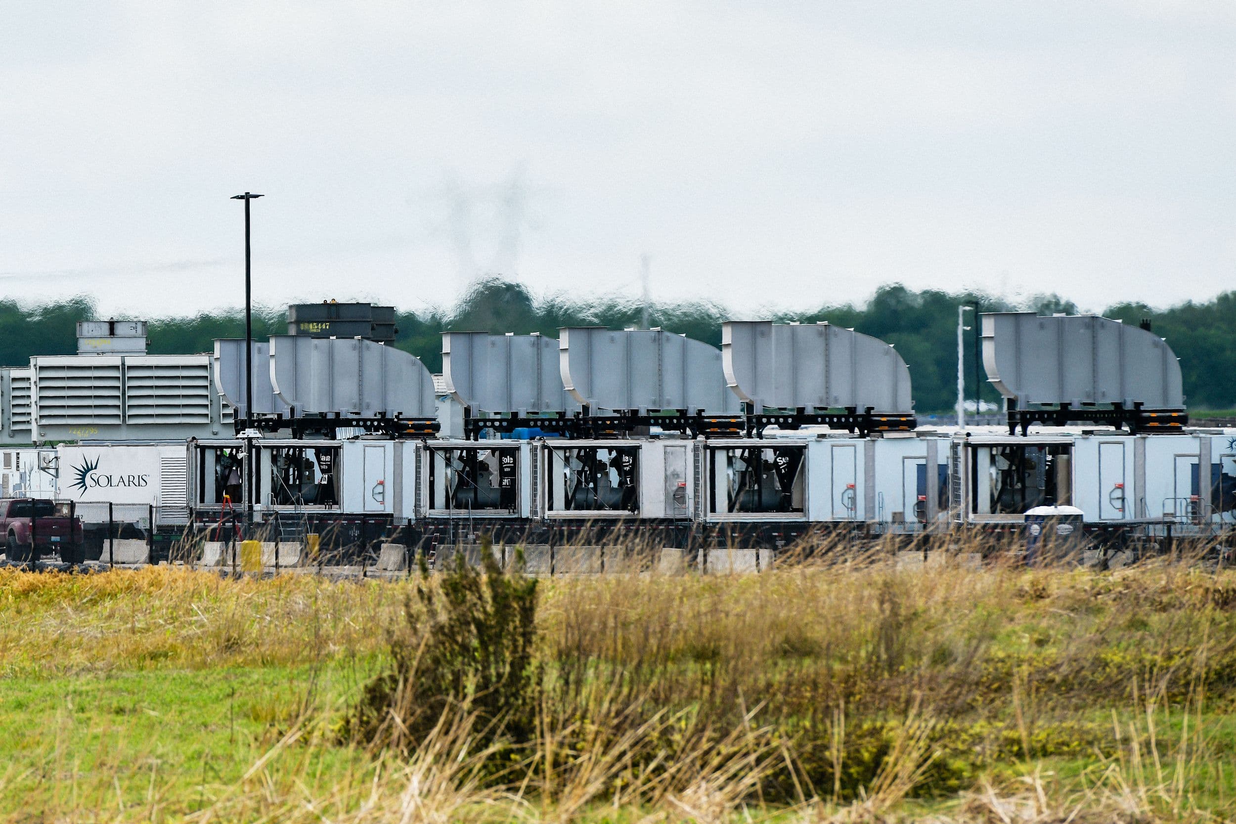 Aerial view of xAI's Colossus 2 data center with gas turbines
