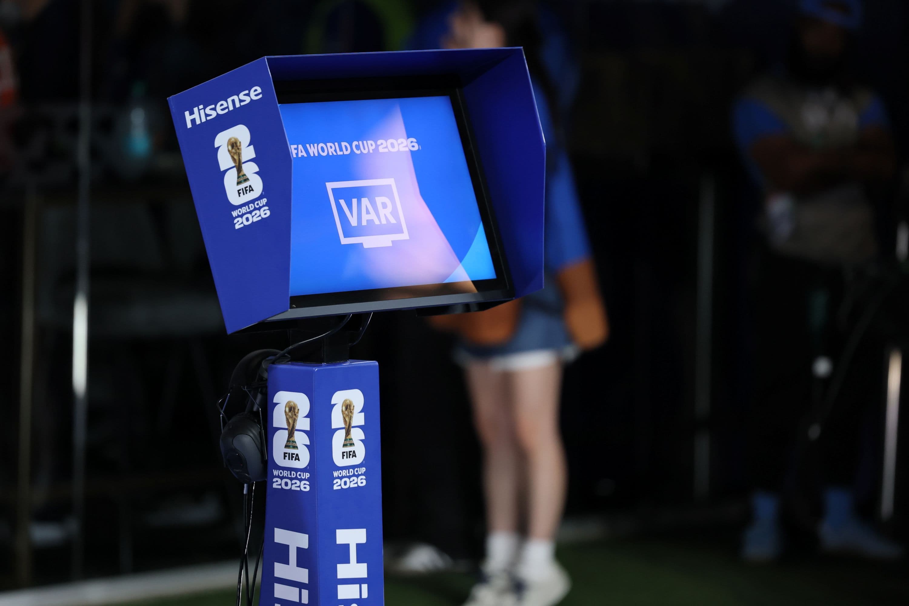 Fans debating VAR decisions during the 2026 World Cup matches.