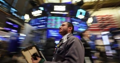 Investors analyzing the impact of AI on the software market stability.