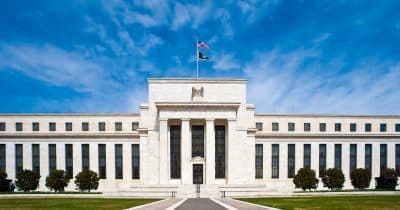 Federal Reserve building with digital currency graphics