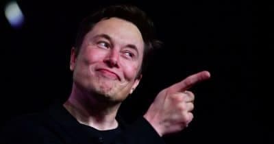 Elon Musk in front of a Twitter logo, symbolizing the legal challenges he faces.