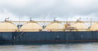 A damaged LNG tanker in the Strait of Hormuz following a drone attack.