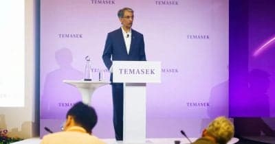 Temasek Holdings logo with a backdrop of AI technology graphics.