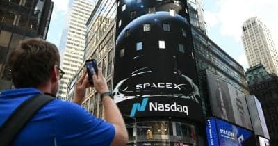 Samsung Electronics logo with a backdrop of financial market graphics.