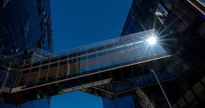 OpenAI logo with a backdrop of cybersecurity imagery