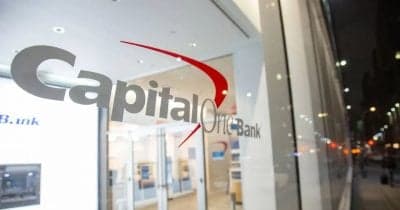 Capital One logo with a backdrop of financial documents and regulations