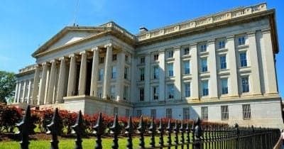 US Treasury building with financial graphs overlay