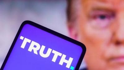 Trump Media logo with a backdrop of cryptocurrency symbols