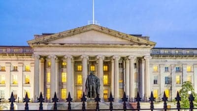 U.S. Treasury building with cryptocurrency symbols in the foreground