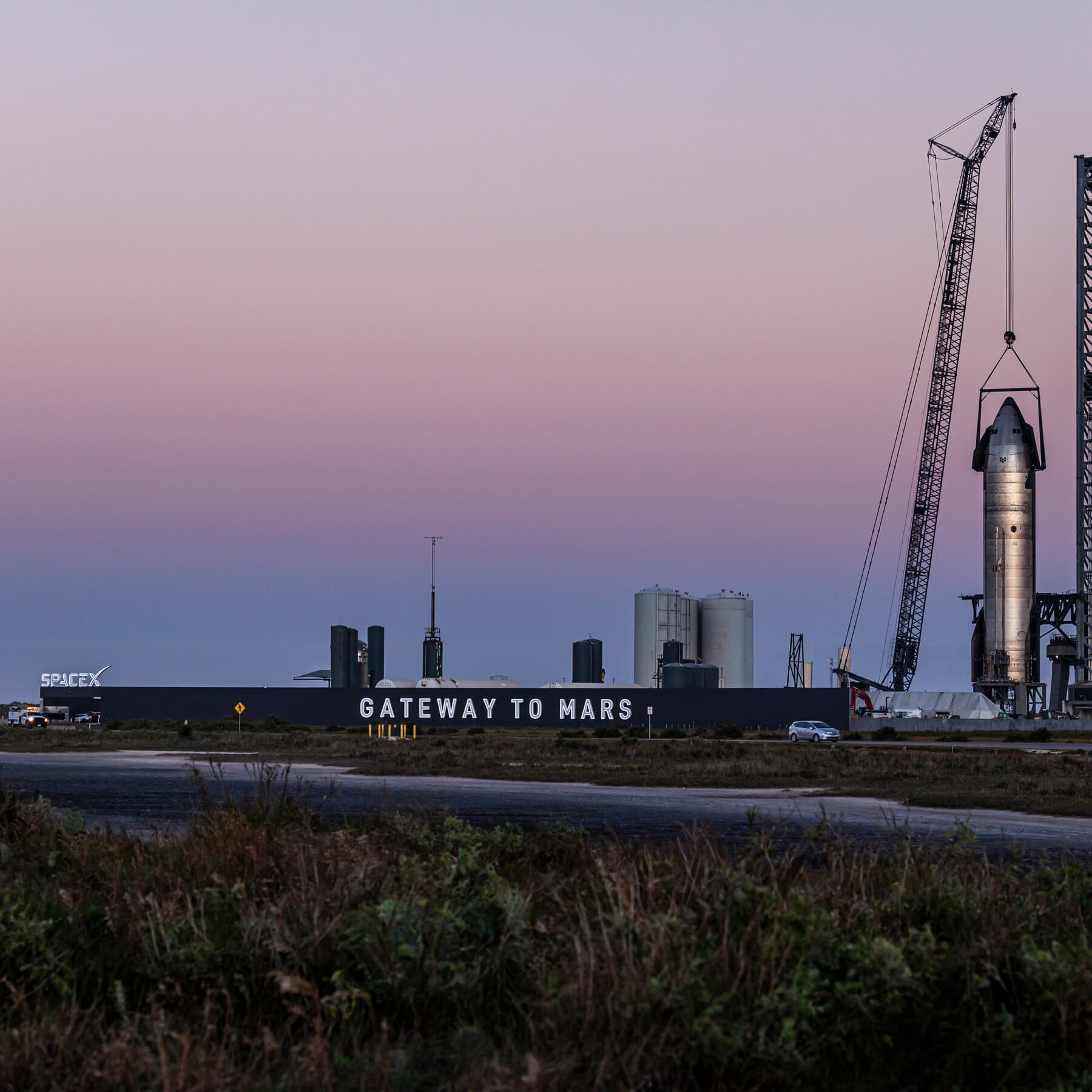 SpaceX logo with a backdrop of semiconductor chips and AI graphics.