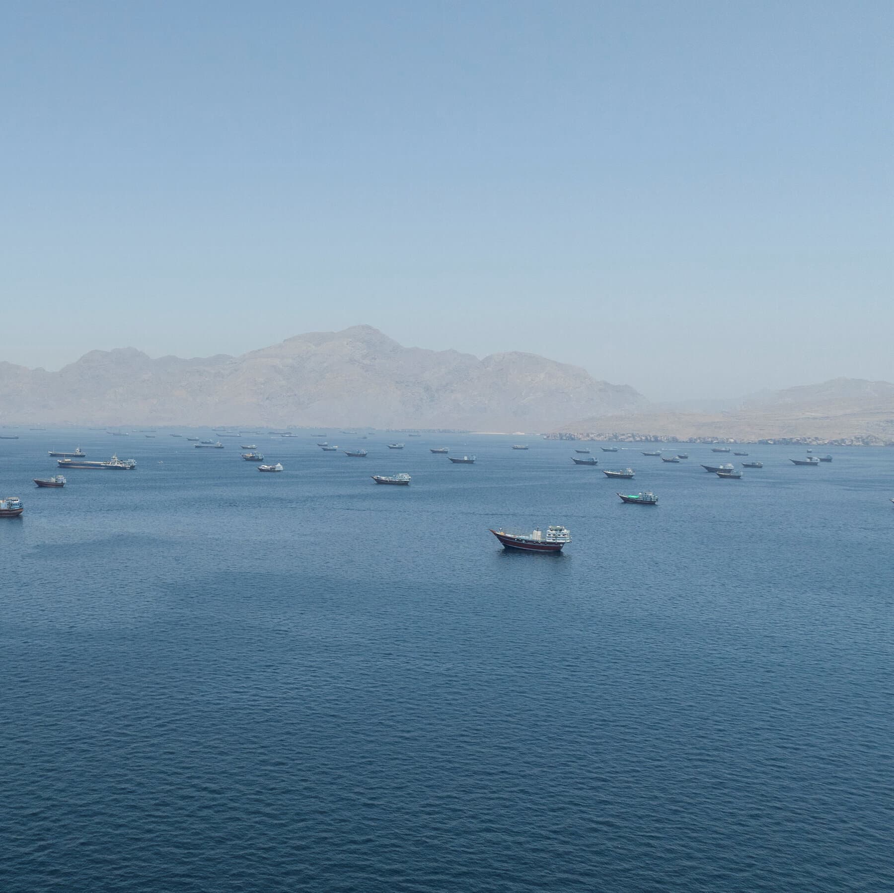 Map of the Strait of Hormuz highlighting shipping routes and military presence.