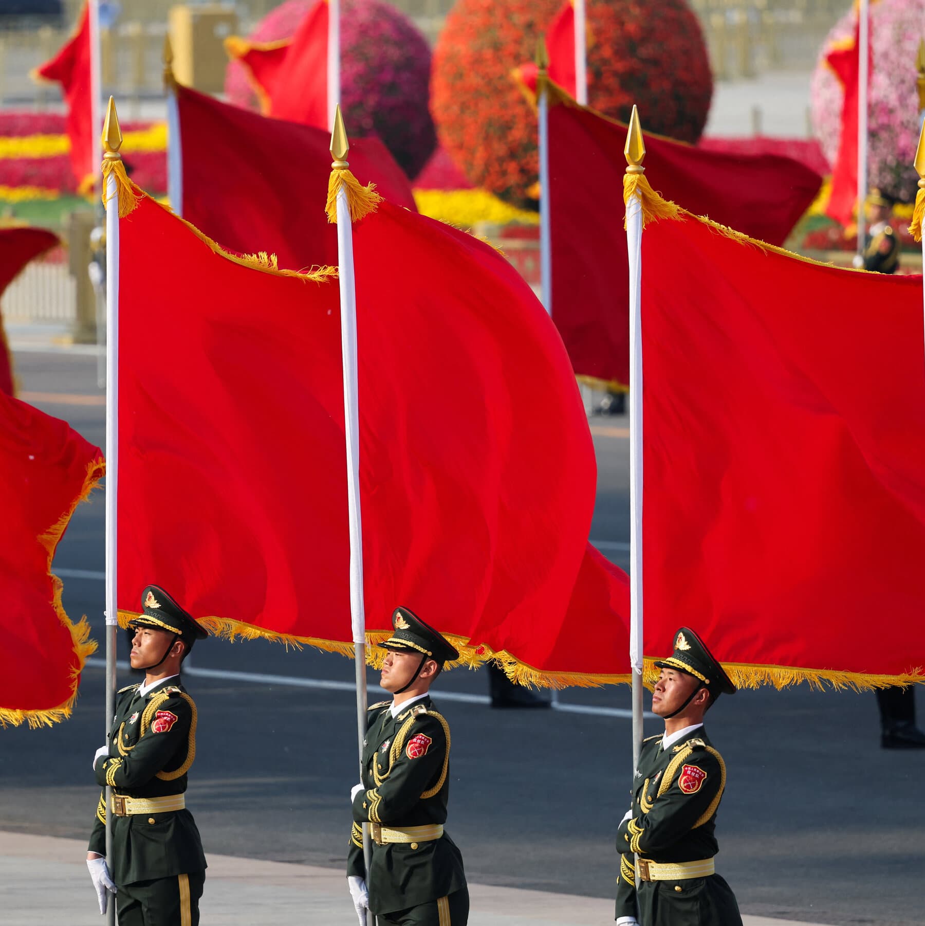 Chinese military personnel examining advanced technology in a strategic setting.