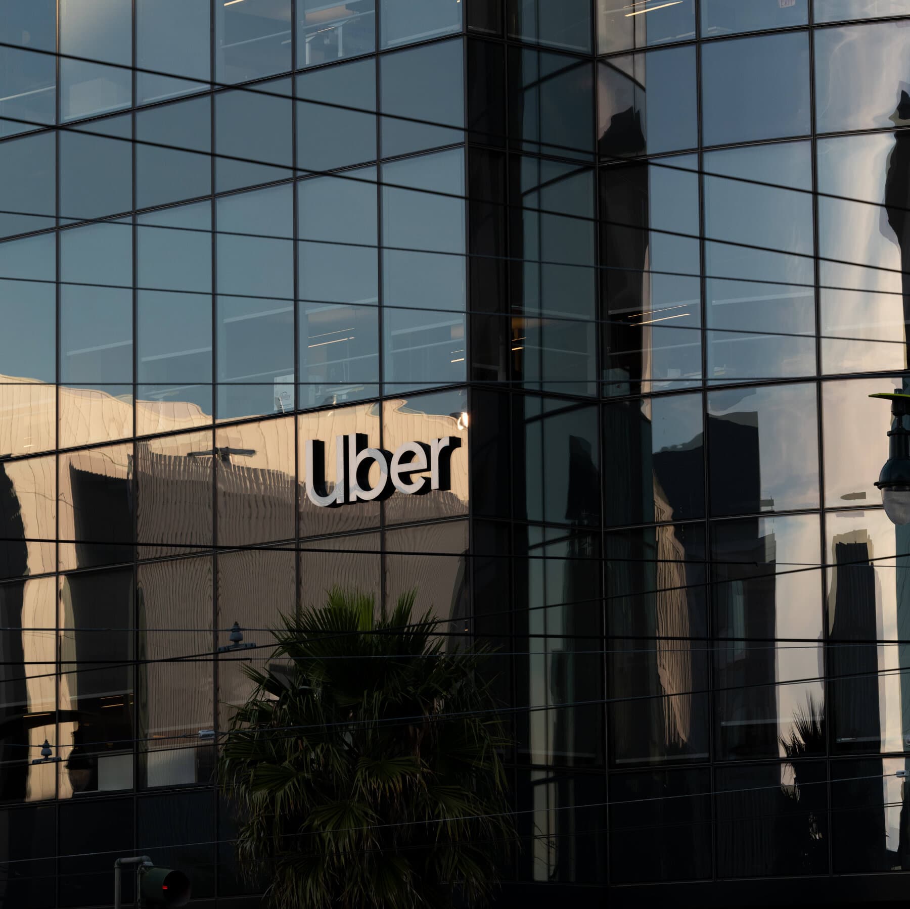 Uber logo with a background of a city skyline representing ride-sharing safety.