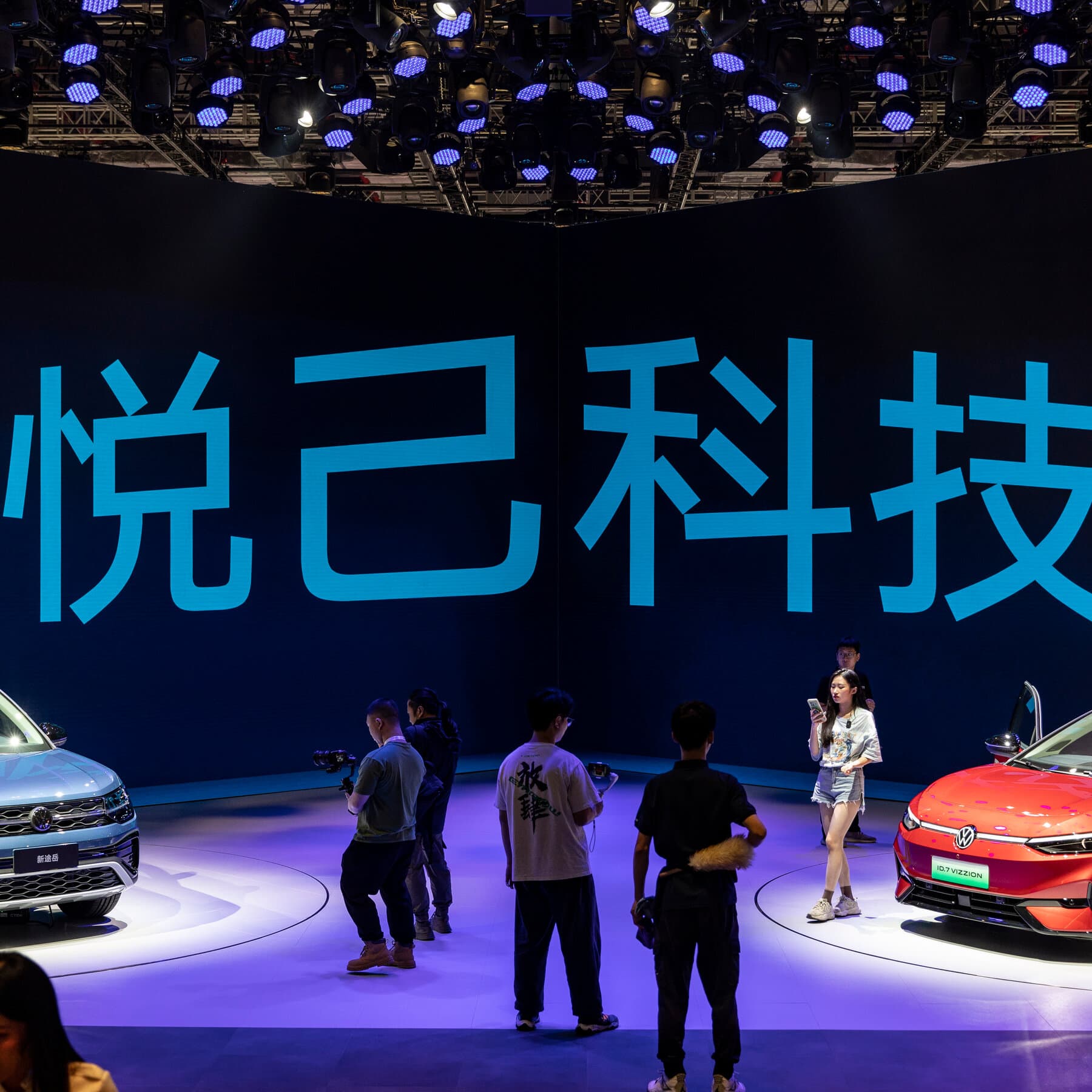 Volkswagen and BMW logos with a backdrop of declining sales charts in China.