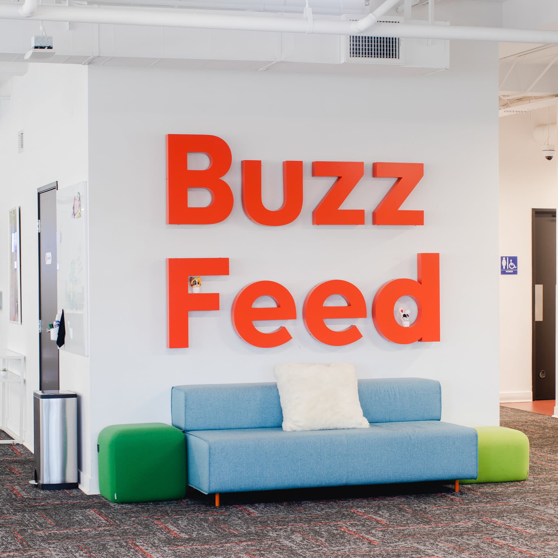 BuzzFeed logo with a backdrop of digital media graphics
