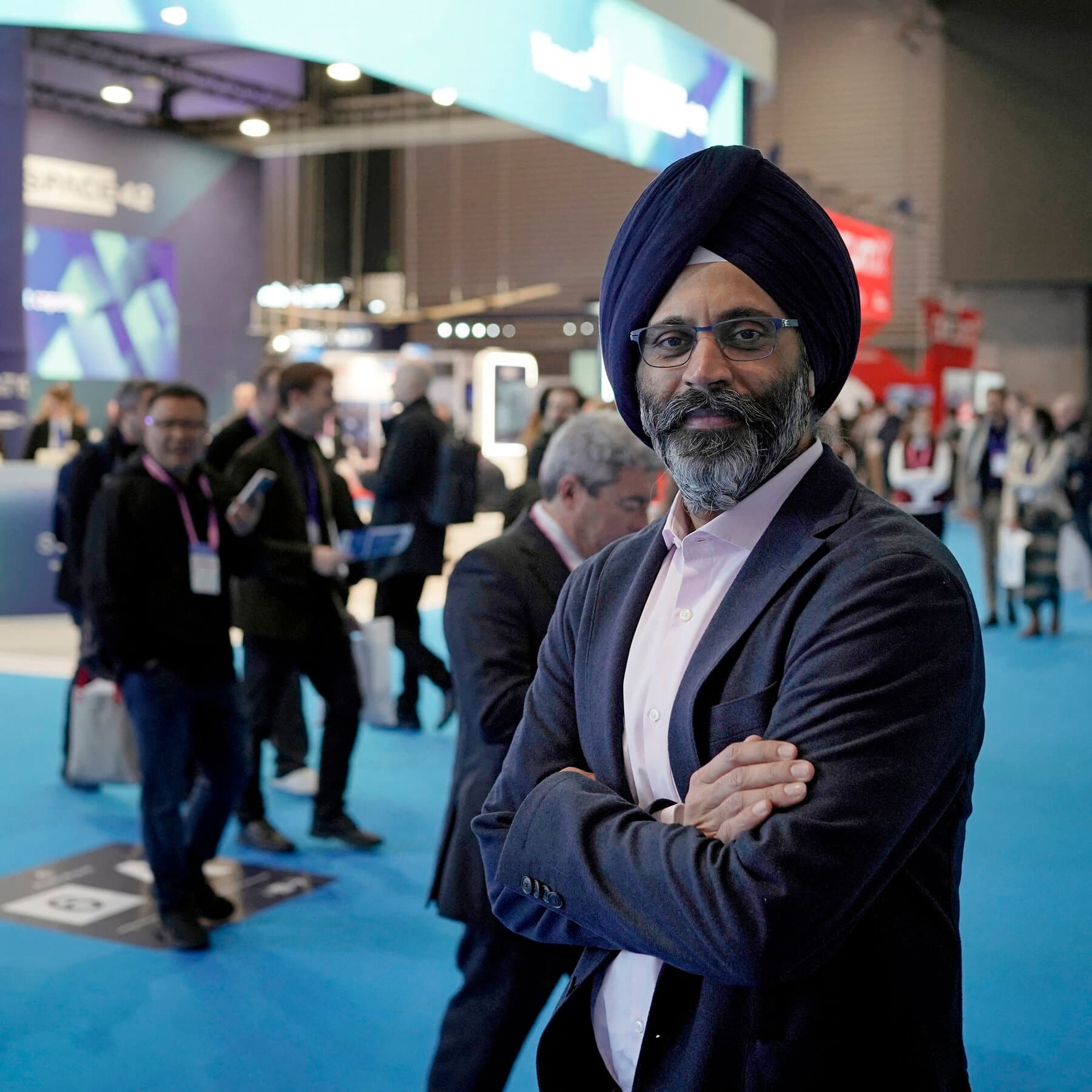 Karandeep Anand, Disney's first CTO, with AI technology elements representing the company's new direction.