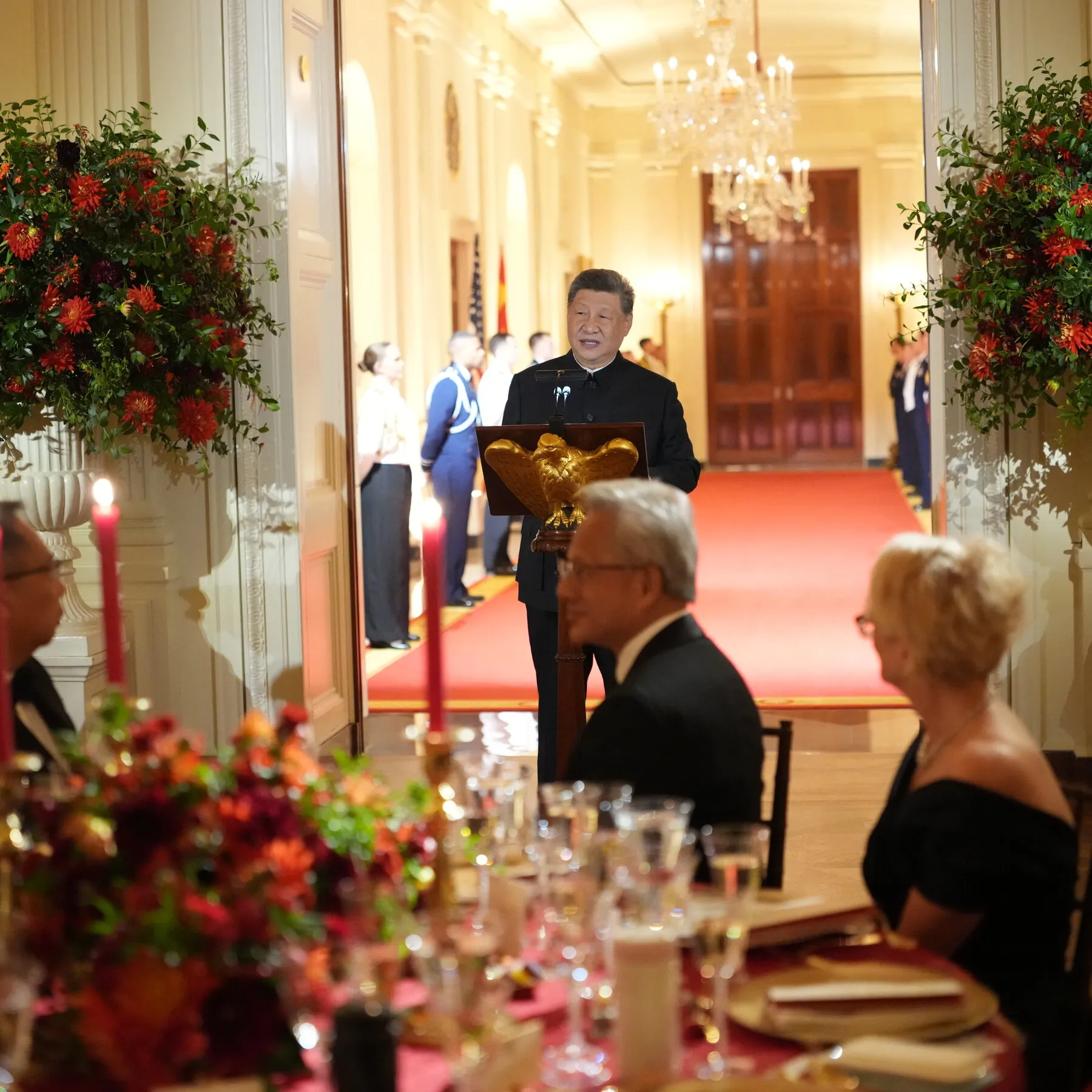 President Trump and Xi Jinping at a state dinner with tech leaders, symbolizing U.S.-China relations and AI discussions.