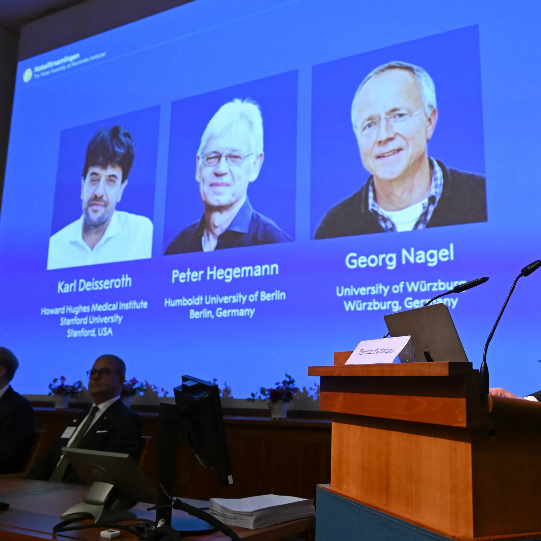 Illustration of Nobel Prize winners with neurons, highlighting optogenetics discoveries.